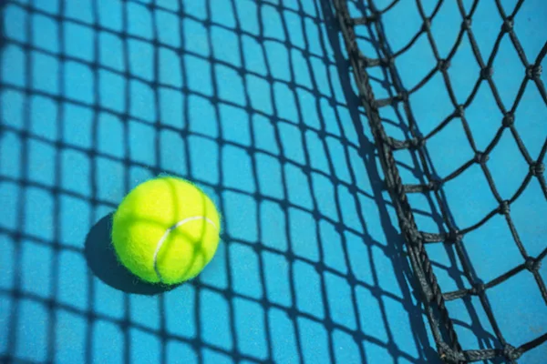 Sommar sport koncept med tennis boll och netto på hård tennis bana. — Stockfoto