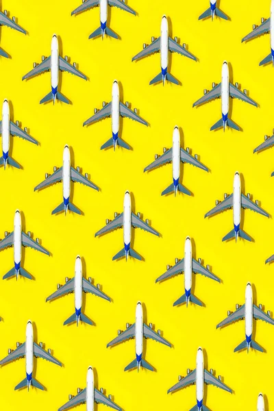 Pattern made of model airplane on yellow background. — Stock Photo, Image