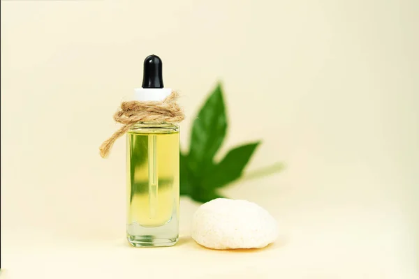 Glass bottles with herbal CBD oil, THC tincture, sponge and hemp leaf . Stock Picture