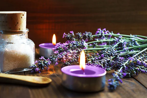 Spa massage setting with lavender flowers, aroma candles and salt on wood — Stock Photo, Image