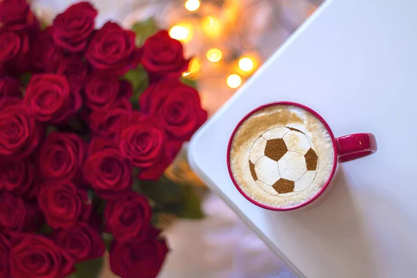 background of cappuccino in cup with a pattern of soccer ball on a milk foam