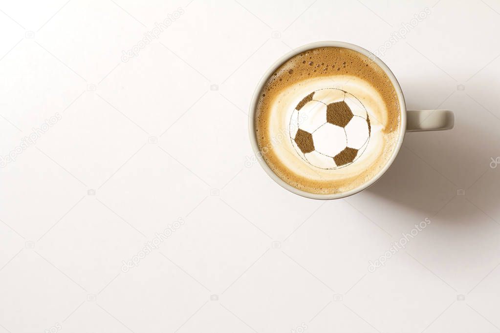 background of cappuccino in cup with a pattern of soccer ball on a milk foam