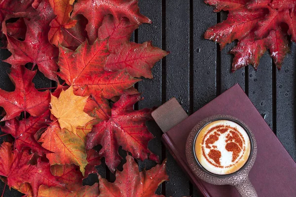 a cup of cappuccino coffee with a pattern of the planet earth made of cinnamon on milk foam