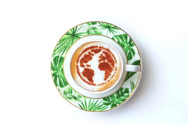 a cup of cappuccino coffee with a pattern of the planet earth made of cinnamon on milk foam