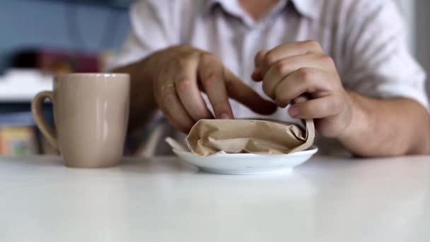 Man Unpacks Sandwich While Sitting Cafe — Stock Video
