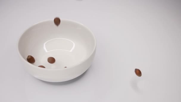 Slow Motion Video Nuts Thrown White Plate — Stock Video