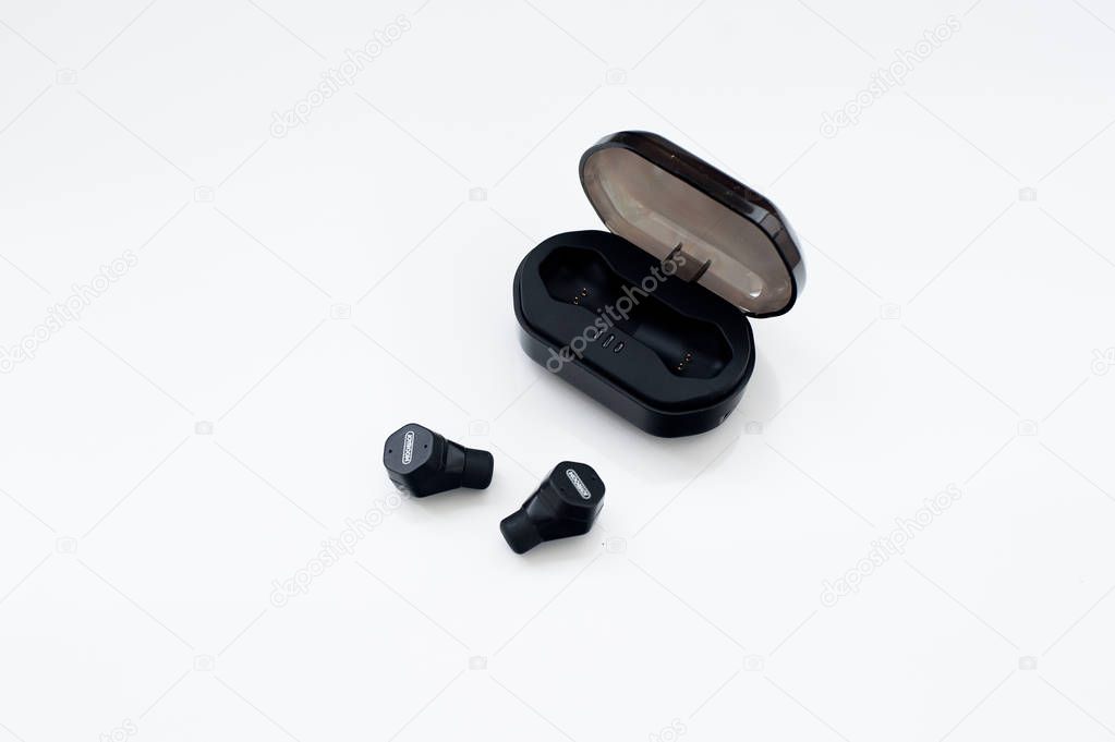Black true wireless earphones with charging case isolated on white background. New fitness sports wireless headphone. Earbuds