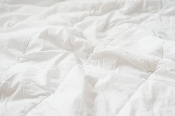 Crumpled quilt white blanket texture. Close up — Stock Photo, Image