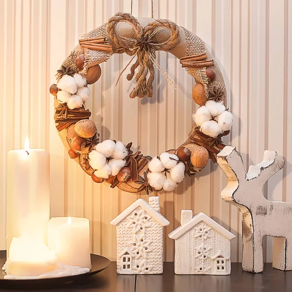 Natural christmas wreath with cotton, nuts, cinnamon and decorations