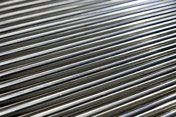 Metal pipes, metal rods steel and iron. Shallow depth of field, selective focus.