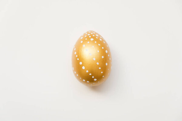 Easter golden decorated egg  isolated on white background. Minimal easter concept. Top view, flatlay.  