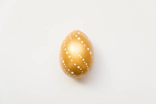 Easter golden decorated egg  isolated on white background. Minimal easter concept. Top view, flatlay.  