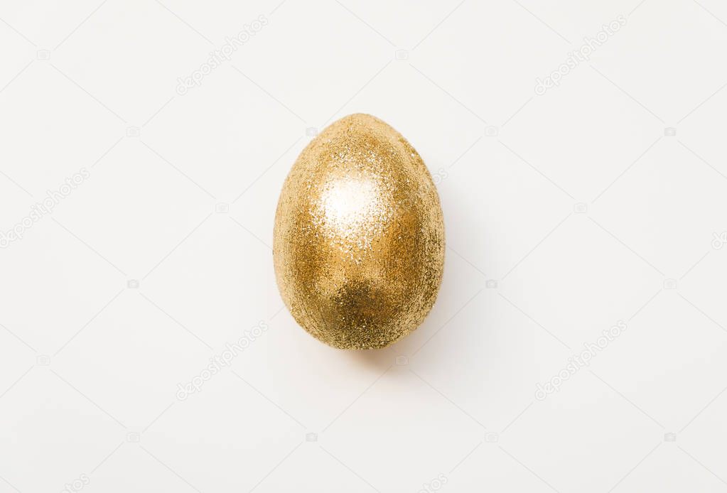 Easter golden glitter egg  isolated on white background. Minimal easter concept. Happy Easter card. Top view, flatlay.  