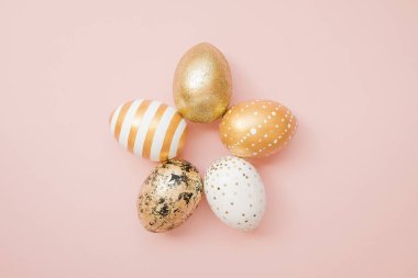 Paskalya altın yumurta pastel pembe arka plan üzerine dekore edilmiştir. En az Paskalya kavramı. Metin kopya alanı ile mutlu Paskalya kartı. T