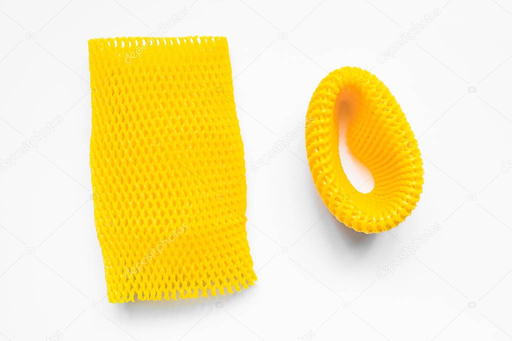 Yellow EPE fruit nets close-up isolated. Expanded polyethylene foam mesh for Fruit Wrap To prevent bumps.