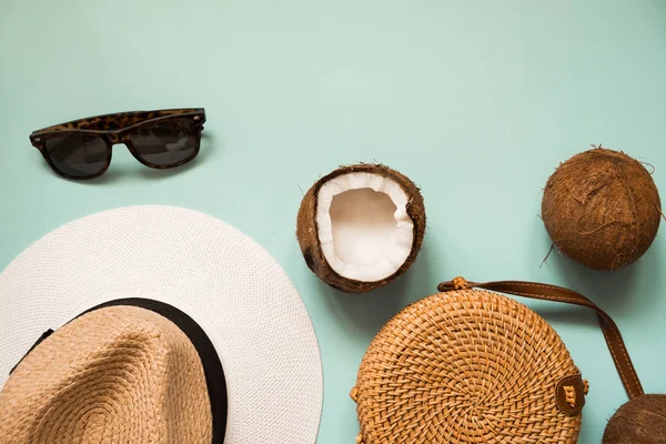 Flat lay with ripe coconuts on blue background. Creative summer layout with sunglasses, straw hat, bamboo bag. — Stock Photo, Image