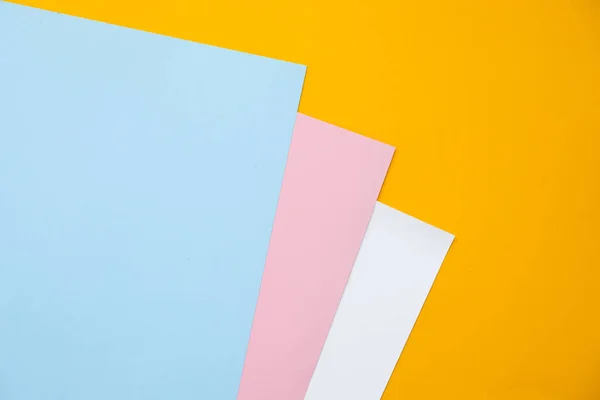 Blue, yellow and pink pastel color paper geometric flat lay background. — Stock Photo, Image
