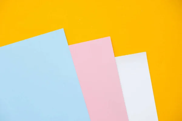 Blue, yellow and pink pastel color paper geometric flat lay background. — Stock Photo, Image
