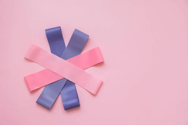 Colorful fitness gums on pink background. Elastic expanders