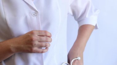 Close-up of a doctor's hands holding a stethoscope. Concept of medicine and health. Cardiologist in a white coat with a stethoscope in his hands. Doctor, nurse or intern. Medical instrument