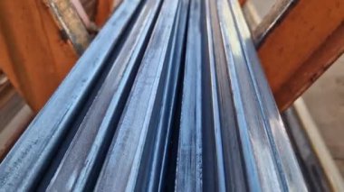 Rectangular steel profile pipes in a metal warehouse, selective focus. Building materials. Close-up of rectangular metal profile pipes stacked together. Building materials warehouse