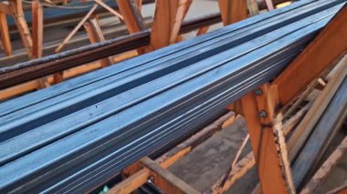 Rectangular steel profile pipes in a metal warehouse, selective focus. Building materials. Close-up of rectangular metal profile pipes stacked together. Building materials warehouse