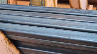 Rectangular steel profile pipes in a metal warehouse, selective focus. Building materials. Close-up of rectangular metal profile pipes stacked together. Building materials warehouse