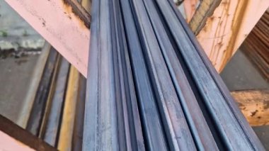 Rectangular steel profile pipes in a metal warehouse, selective focus. Building materials. Close-up of rectangular metal profile pipes stacked together. Building materials warehouse
