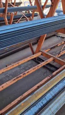 Rectangular steel profile pipes in a metal warehouse, selective focus. Building materials. Close-up of rectangular metal profile pipes stacked together. Building materials warehouse