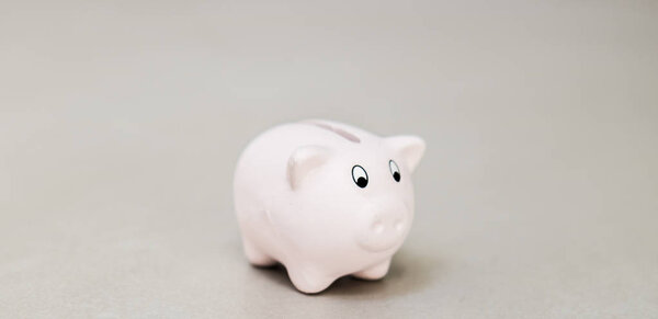 Closeup of white piggy bank on grey background, investment and banking concept