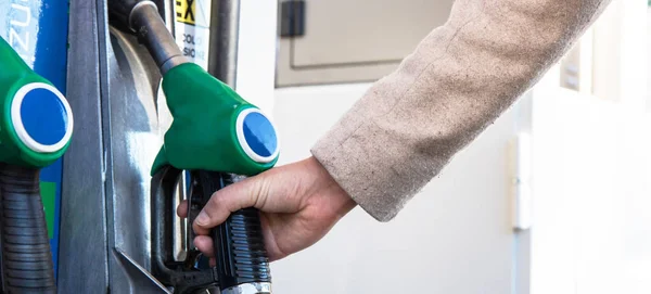 hand of young woman at the gasoline station