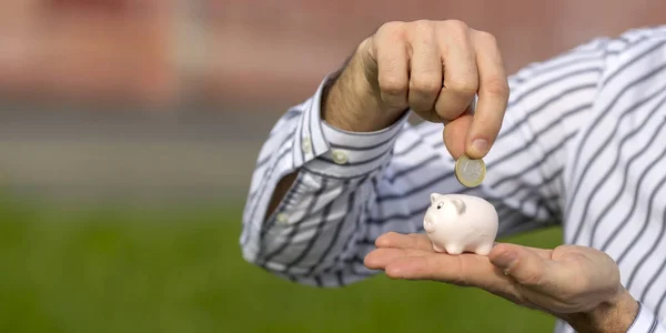 cropped image of man holding little piggy bank