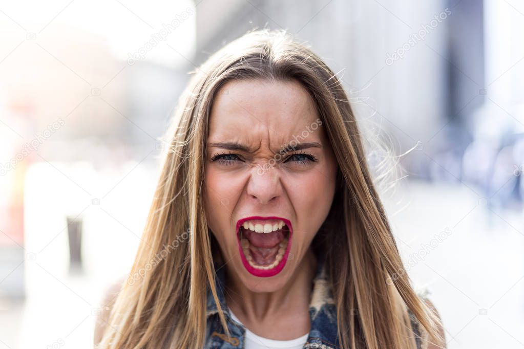Angry and screaming young girl portrait photo 