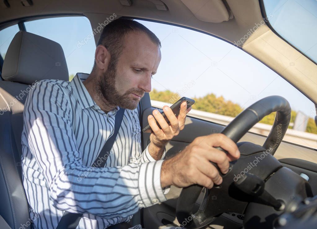 Dangerous man driving while using his mobile phone