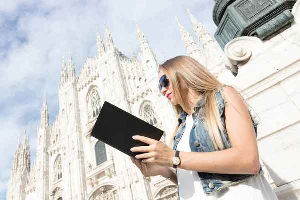 Portrait of young woman tourist with guide book in Milan, Italy