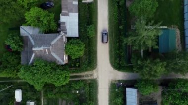 Köy yolu. Arabayı yolda ağaçlar arasında sürmek ve evler.