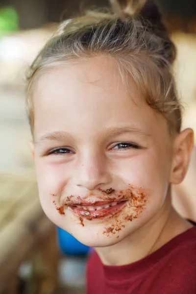 Boy eating pancake with banana and chocolate — Stock Photo, Image