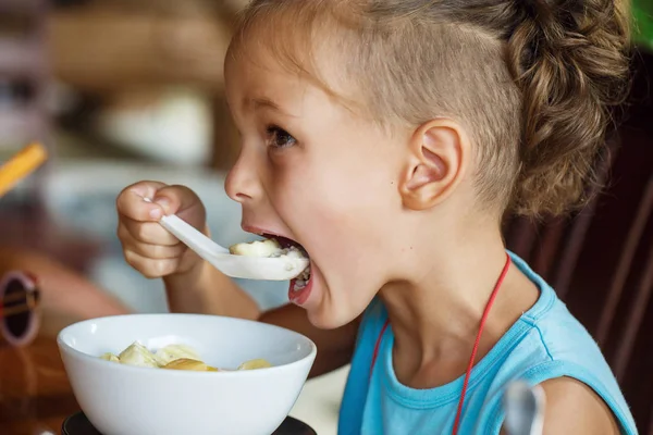 Beautiful boy is having breakfast with  porridge — Stock Photo, Image