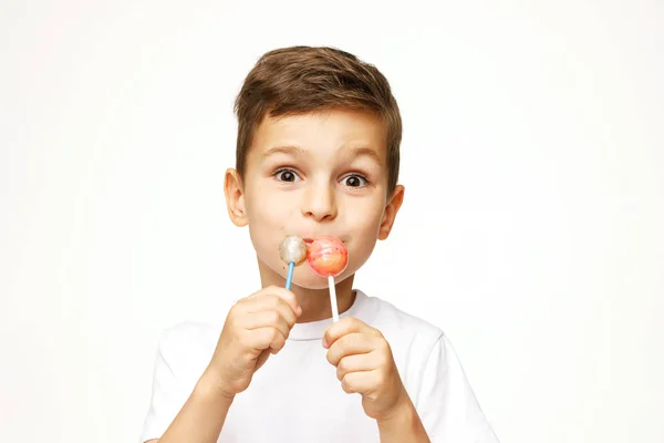 Little boy with a lollipop on a white background Stock Photo