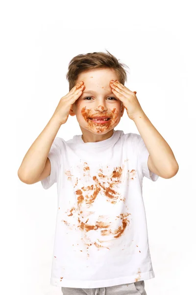 Little boy with face and hands in chocolate — Stock Photo, Image