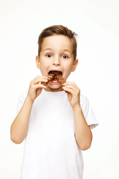 Little beautiful boy holding chocolates studio shot — Stock Photo, Image