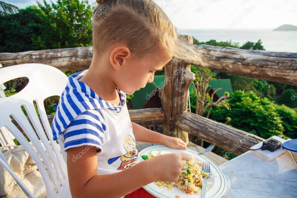 Little boy is on the dinner in Thailand 