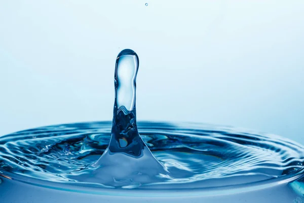 Drop of water falling down in the water — Stock Photo, Image