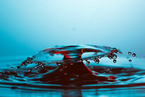 Drop of water falling down in the water — Stock Photo, Image