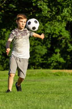 Pre-Teen Çocuk bir parkta futbol oynamaktan