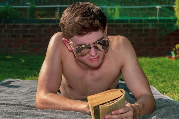 Jovem Adulto Sexo Masculino Deitado Sol Lendo Livro — Fotografia de Stock