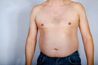 Overweight shirtless caucasian man standing up viewed from the front clipart