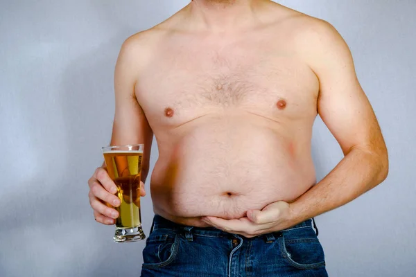 Overweight shirtless caucasian man holding a beer