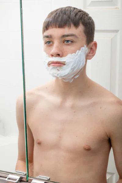 Teenage boy shaving in the morning — Stock Photo, Image