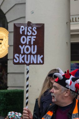London, United Kingdom, September 17th 2025: The Stop Trump Coalition March in Central London. A Protester holds a sign reading piss off you skunk